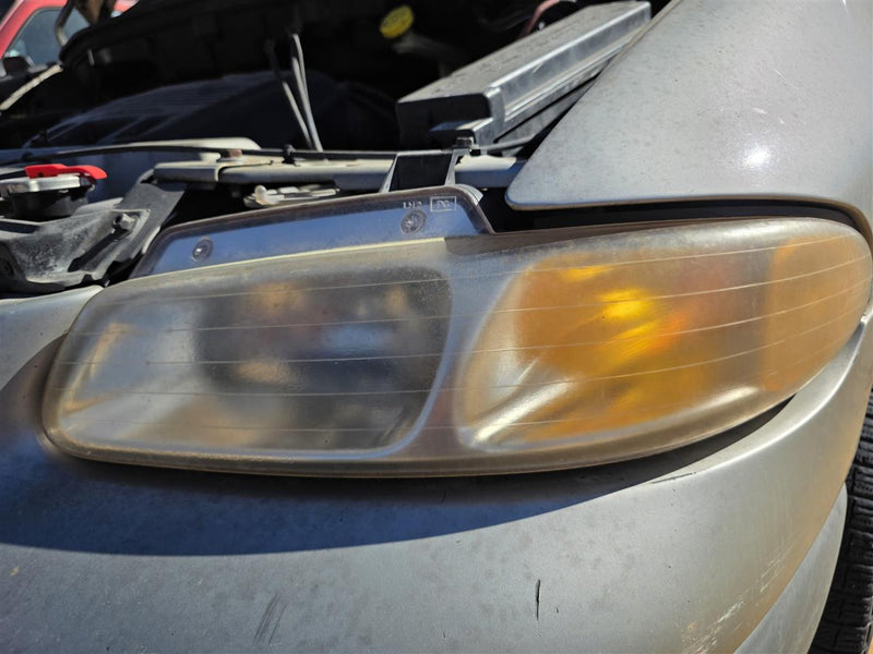 Used OEM Driver Side Left Headlight Headlamp Assembly from 1996 Jeep Voyager